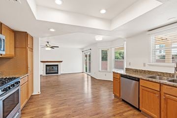 Oro Valley apartment for rent - A kitchen with wooden cabinets and a stainless steel dishwasher.