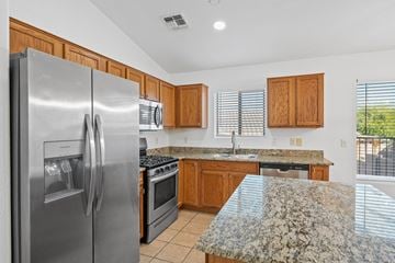 Vail apartment for rent - A kitchen with granite countertops and stainless steel appliances.