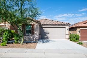 Sahuarita apartment for rent - A house with a brown roof and a white garage door.