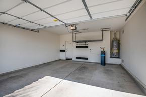 Sahuarita apartment for rent - A spacious garage with a white floor and a white ceiling with a light fixture.