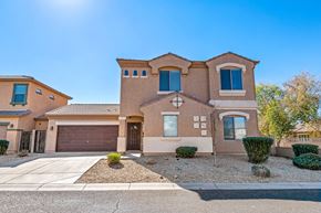 Peoria apartment for rent - a house with a garage and a driveway in front of it
