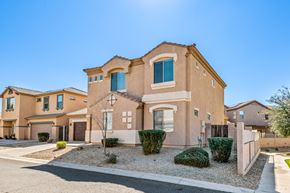 Peoria apartment for rent - a brick house with green shutters and a sidewalk in front of it