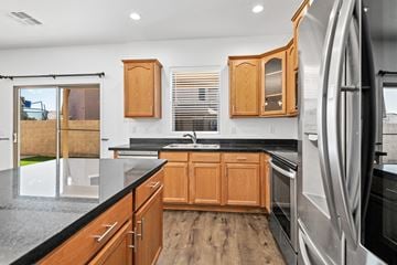 Peoria apartment for rent - A modern kitchen with wooden cabinets and a black countertop.