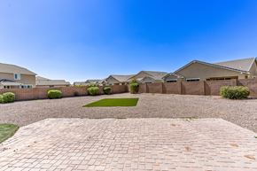 Queen Creek apartment for rent - A row of houses with a gravel driveway in the foreground.