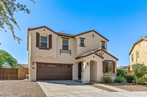 Queen Creek apartment for rent - A two-story house with a garage is surrounded by a gravel driveway and a wooden fence.