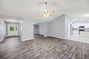 Milford apartment for rent - A spacious room with a ceiling fan and lighting fixture.