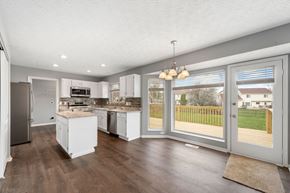 Batavia apartment for rent - A kitchen with white cabinets and a refrigerator.