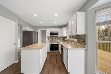 Batavia apartment for rent - A kitchen with white cabinets and a wooden floor.