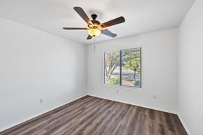Vail apartment for rent - an empty living room with a ceiling fan and a window