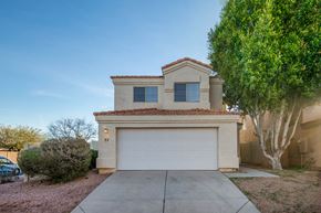 Gilbert apartment for rent - a home with a white garage door and a tree