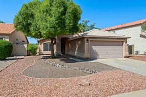 Gilbert apartment for rent - a house with a driveway and a tree in front of it