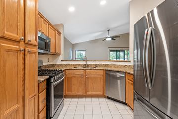 Gilbert apartment for rent - A kitchen with wooden cabinets and stainless steel appliances.