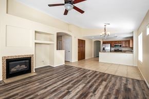 Gilbert apartment for rent - A living room with a fireplace and a fan.