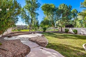 Gilbert apartment for rent - A garden with a circular pathway and a variety of trees.