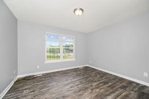 Milford apartment for rent - an empty living room with wood floors and a window