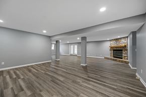 Milford apartment for rent - the living room with a fireplace and wood flooring