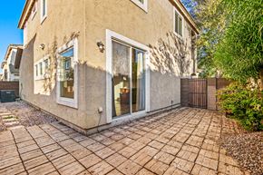 Gilbert apartment for rent - the front of a house with a brick walkway and a gate