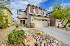 Las Vegas apartment for rent - a beige house with a yard with rocks on the ground