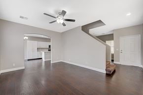 Las Vegas apartment for rent - an empty living room with a ceiling fan and a kitchen