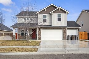 Nampa apartment for rent - a house with a white garage door in front of it