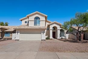 Mesa apartment for rent - a beige house with a garage and a driveway