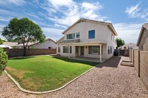 Mesa apartment for rent - the backyard of a house with a lawn and a fence