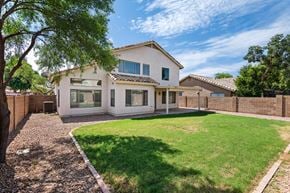 Mesa apartment for rent - a white house with a yard and a fence