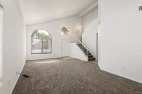 Mesa apartment for rent - the living room of an empty house with carpet and a staircase