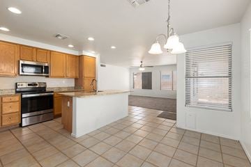Mesa apartment for rent - A kitchen with wooden cabinets and a microwave oven.