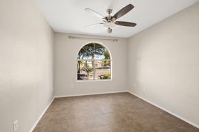 Mesa apartment for rent - an empty living room with a large window and a ceiling fan