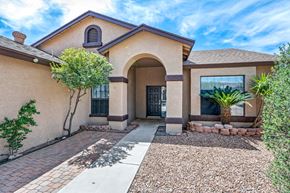 Tucson apartment for rent - A house with a brown roof and a gravel driveway.