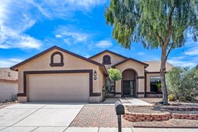Tucson apartment for rent - A house with a brown roof and a grey garage door.