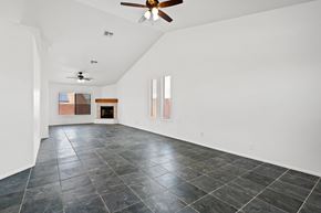 Tucson apartment for rent - A spacious room with a ceiling fan and tiled flooring.