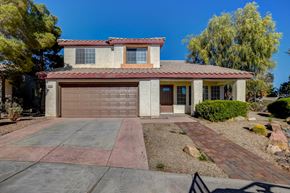 Las Vegas apartment for rent - A house with a brown garage door and a red brick driveway.