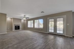 Las Vegas apartment for rent - A spacious living room with a fireplace and sliding glass doors.