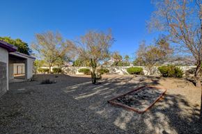 Las Vegas apartment for rent - A backyard with a swing set and trees.
