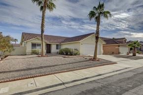 Henderson apartment for rent - A house with a brown roof and a palm tree in front.