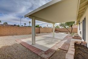 Henderson apartment for rent - A patio with a white roof and red brick border.