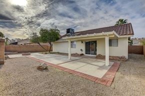 Henderson apartment for rent - A house with a gravel driveway and a tree in front.