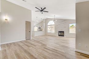 Henderson apartment for rent - A spacious living room with a fireplace and a ceiling fan.