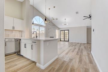 Henderson apartment for rent - A kitchen with white cabinets and a wooden floor.