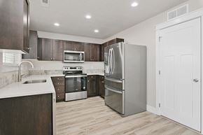 Nampa apartment for rent - a kitchen with stainless steel appliances and wooden cabinets
