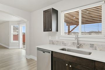 Nampa apartment for rent - A kitchen with a sink and a window with blinds.