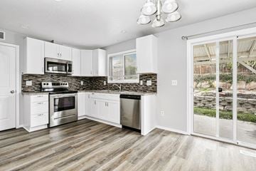 Nampa apartment for rent - A kitchen with white cabinets and a stone backsplash.