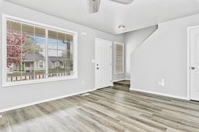 Nampa apartment for rent - the living room of a new home with a large window and wooden floors