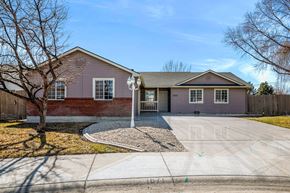 Meridian apartment for rent - a pink house with a driveway and a tree