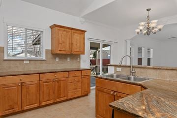 Meridian apartment for rent - A kitchen with wooden cabinets and a granite countertop.