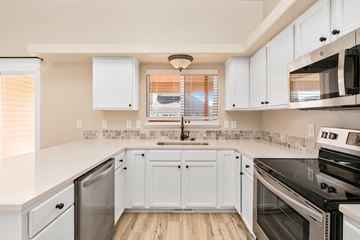Boise apartment for rent - A kitchen with white cabinets and appliances.