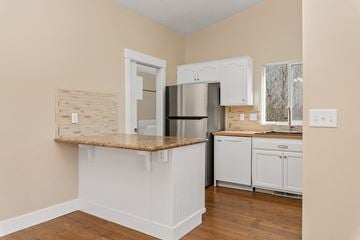 Meridian apartment for rent - A kitchen with white cabinets and a granite countertop.