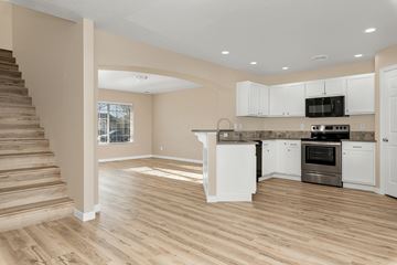 Meridian apartment for rent - A spacious kitchen with white cabinets and a stainless steel oven.